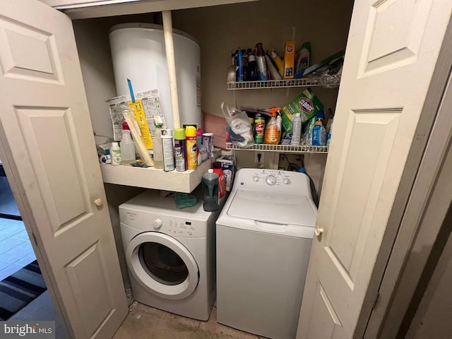 clothes washing area featuring washer and clothes dryer and water heater