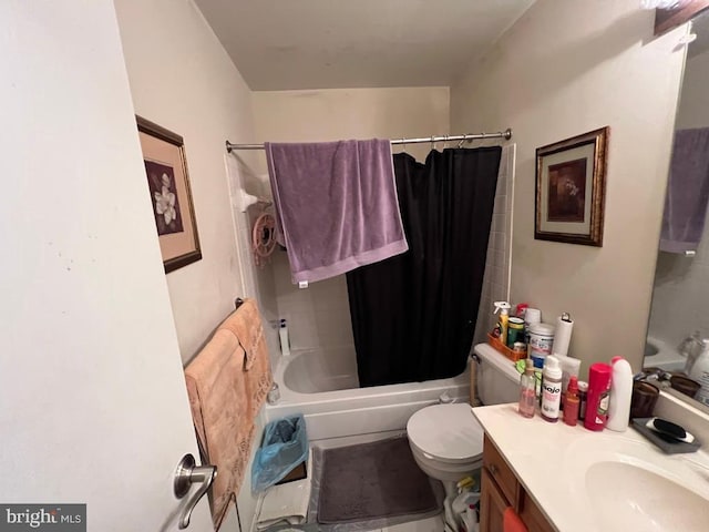 full bathroom featuring toilet, vanity, and shower / bath combo with shower curtain