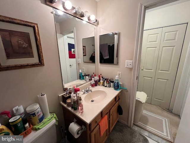 bathroom featuring vanity and toilet