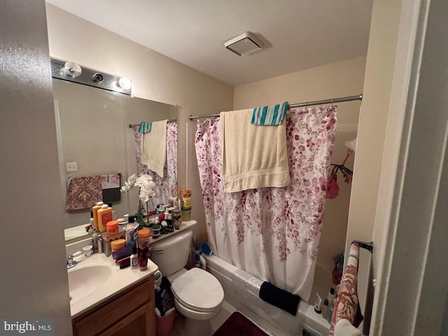 full bathroom featuring vanity, shower / tub combo, and toilet