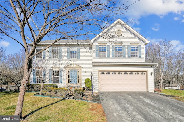 view of front of house featuring a garage and a front yard