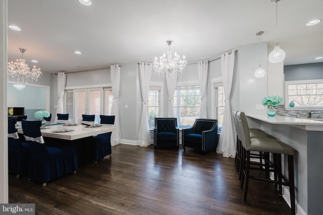 kitchen featuring decorative light fixtures, a breakfast bar area, and dark hardwood / wood-style floors