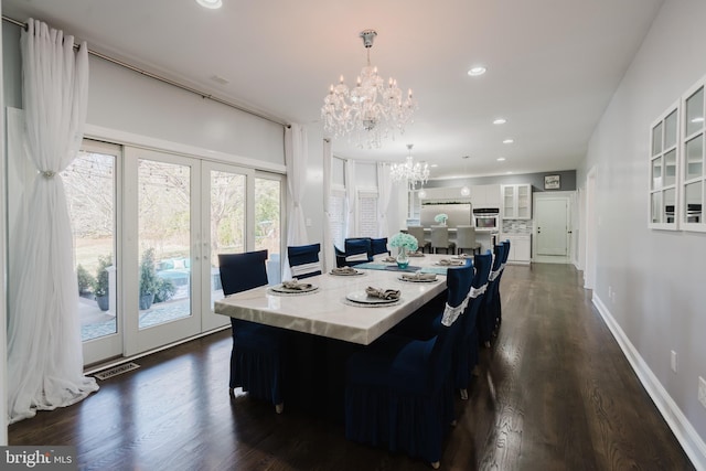 dining room featuring a notable chandelier, dark hardwood / wood-style floors, and french doors