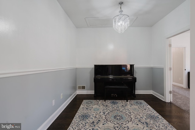 misc room featuring dark hardwood / wood-style floors and a notable chandelier