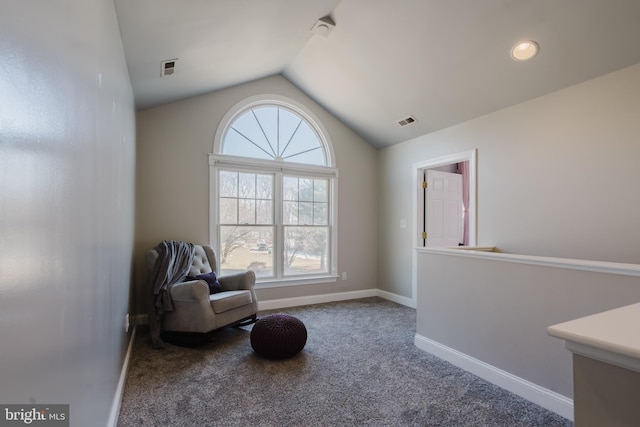 sitting room featuring carpet and lofted ceiling