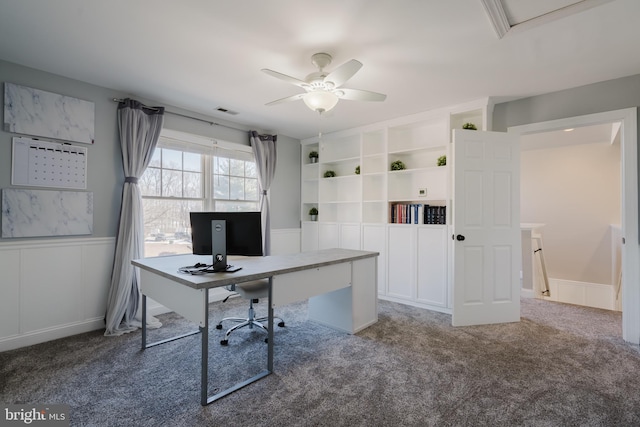 unfurnished office featuring carpet flooring and ceiling fan