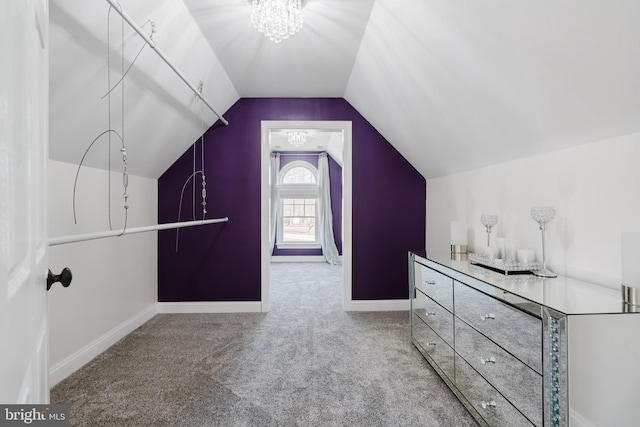 walk in closet featuring lofted ceiling and carpet floors