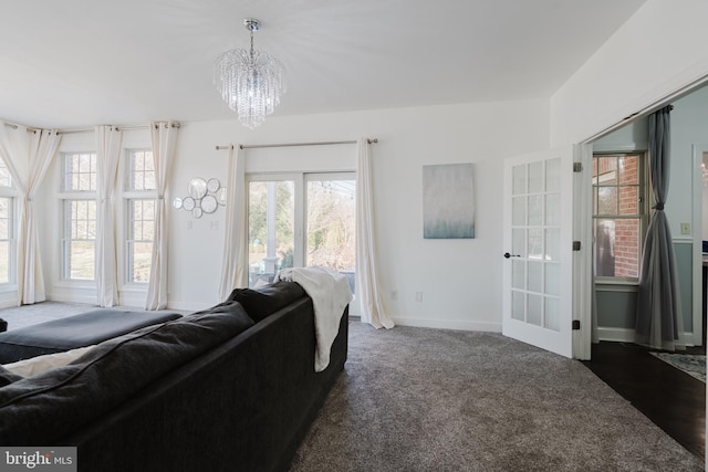 living room with a chandelier and dark carpet