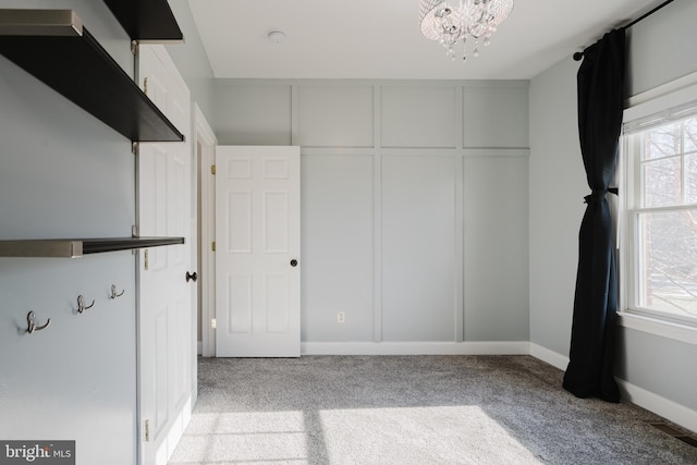 interior space featuring a notable chandelier and light colored carpet