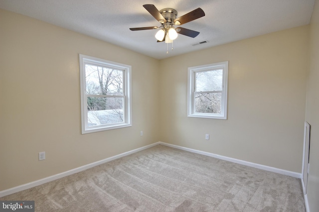 spare room with light carpet and ceiling fan