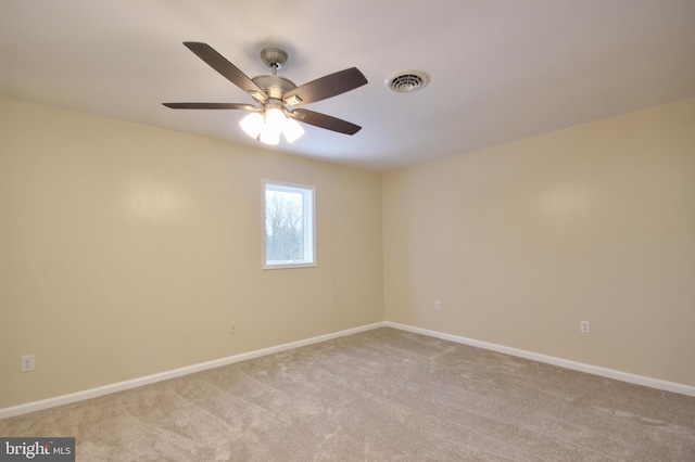 empty room with ceiling fan and light colored carpet