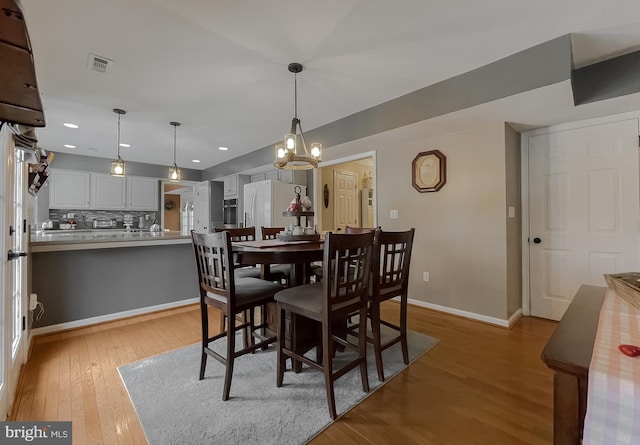 dining space with light wood-type flooring