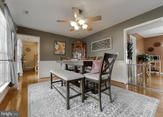 dining room featuring ceiling fan, a healthy amount of sunlight, and light hardwood / wood-style floors