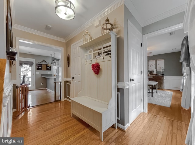 mudroom featuring light hardwood / wood-style flooring and ornamental molding