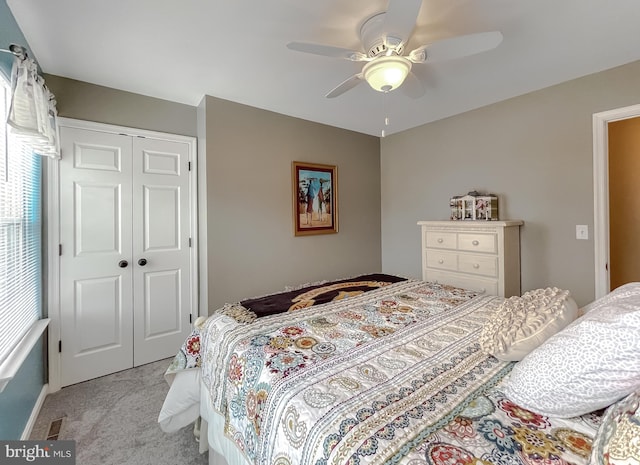 carpeted bedroom featuring a closet and ceiling fan