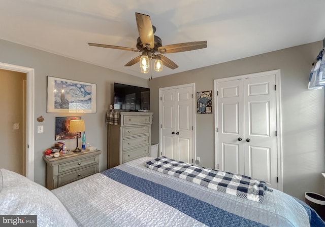 bedroom featuring multiple closets and ceiling fan