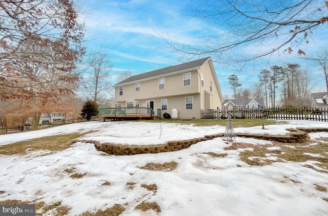 snow covered property featuring a wooden deck