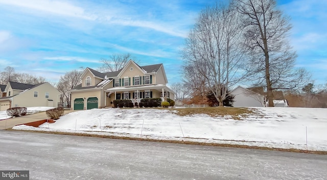 view of front property featuring a porch and a garage