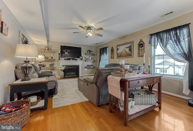 living room with hardwood / wood-style flooring and ceiling fan