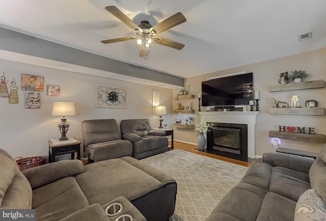 living room with ceiling fan and light wood-type flooring