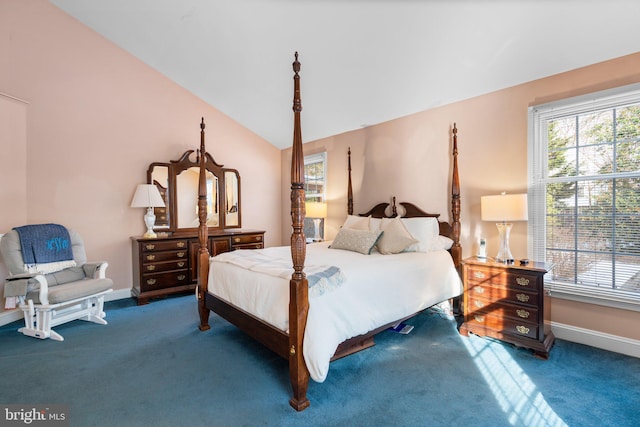 bedroom with multiple windows, vaulted ceiling, and carpet flooring