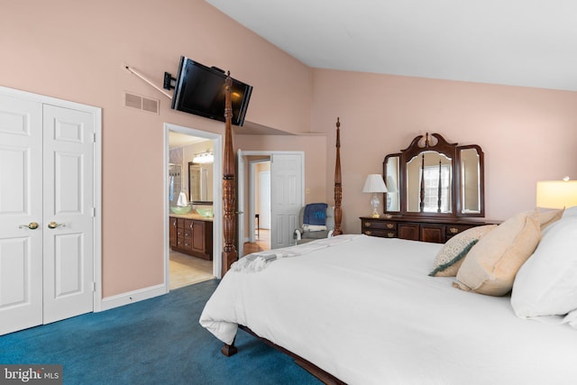 bedroom with light carpet, vaulted ceiling, a closet, and ensuite bathroom