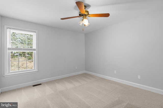 carpeted empty room featuring ceiling fan