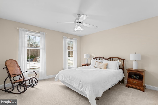 bedroom featuring light colored carpet and ceiling fan