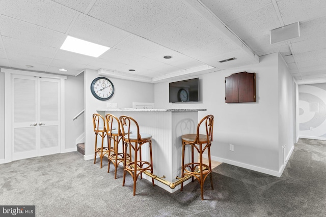 bar with carpet flooring and a drop ceiling