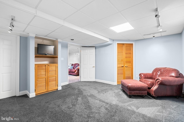 unfurnished room featuring a paneled ceiling and carpet