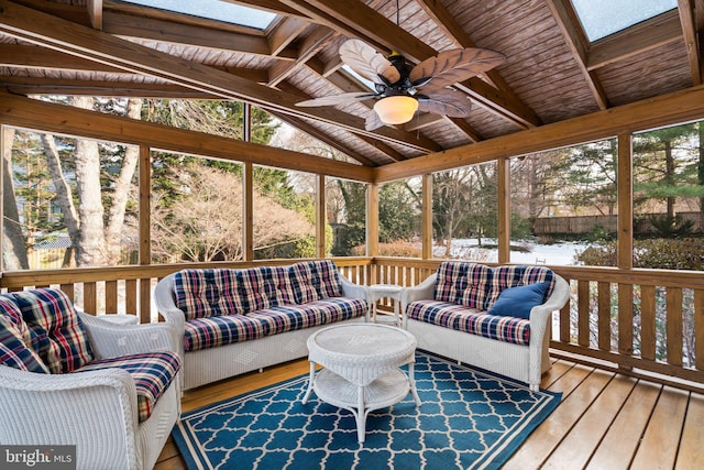 sunroom featuring lofted ceiling with skylight and ceiling fan