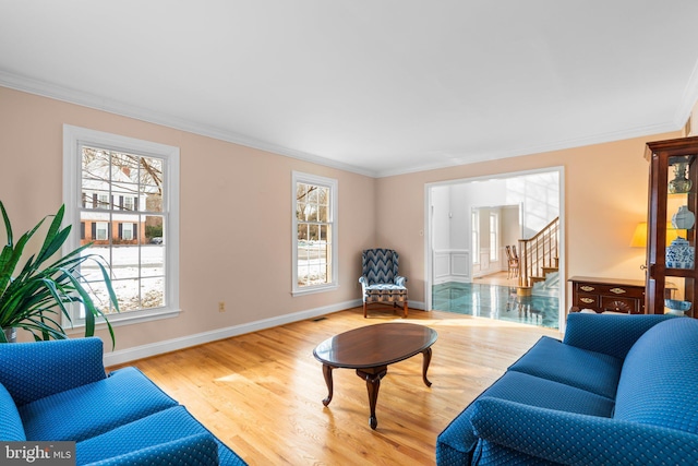 living room with crown molding and light wood-type flooring