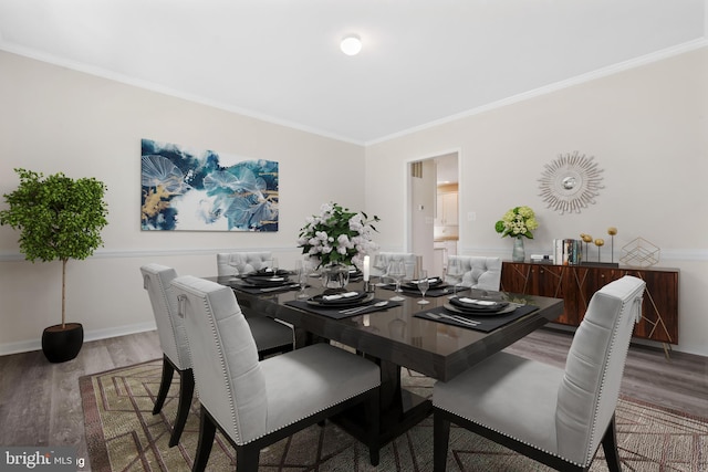 dining space featuring hardwood / wood-style flooring and ornamental molding