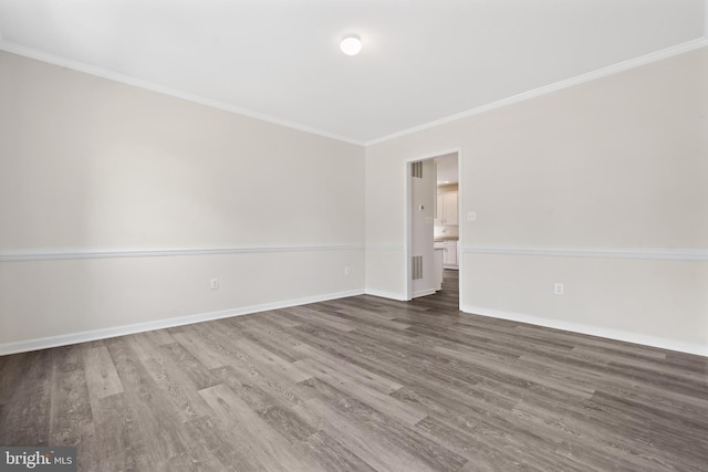 unfurnished room featuring crown molding and dark hardwood / wood-style flooring