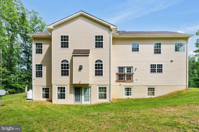 back of house with a lawn