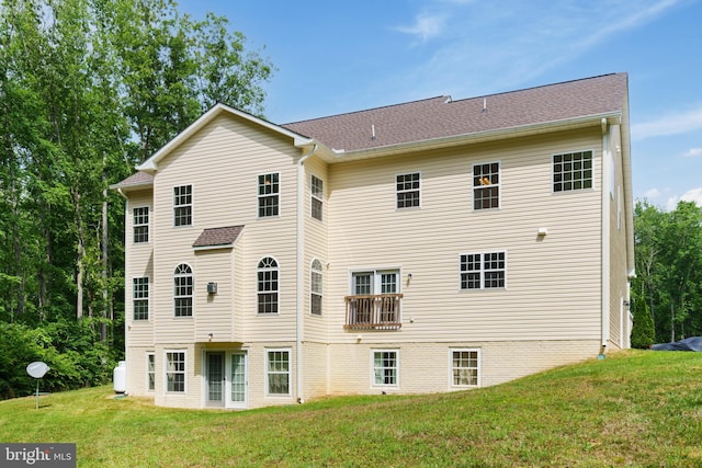 rear view of property with a lawn