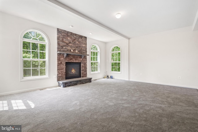 unfurnished living room with carpet flooring and a fireplace