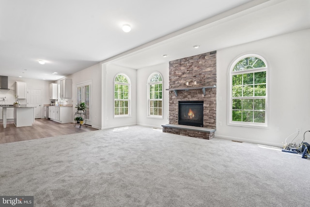 living room with light carpet and a fireplace