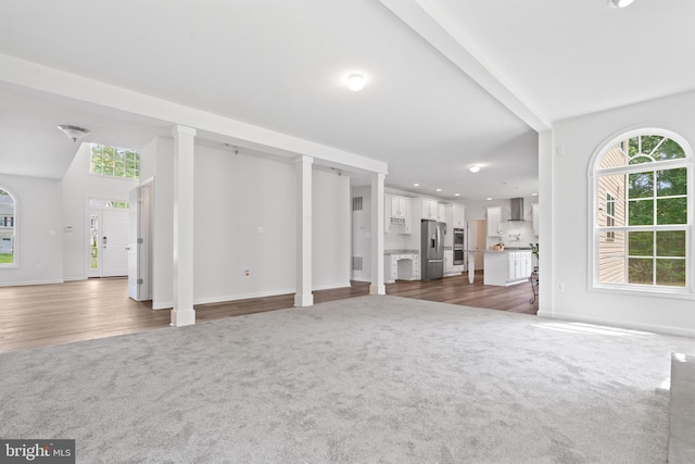 unfurnished living room featuring dark carpet