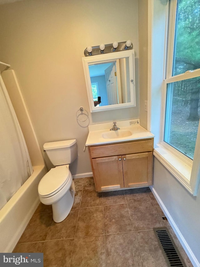 full bathroom featuring toilet, vanity, shower / bath combo, and a healthy amount of sunlight