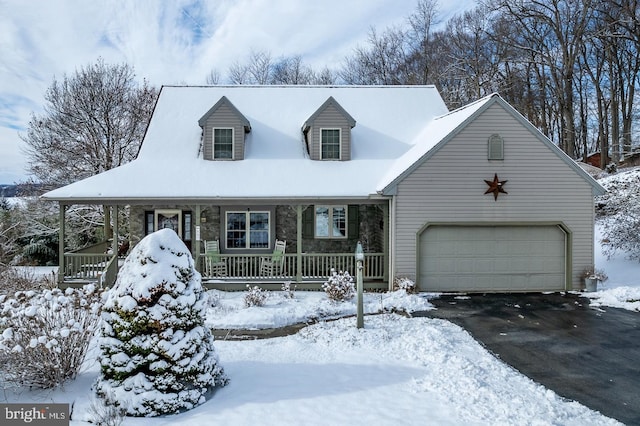 new england style home with covered porch and a garage