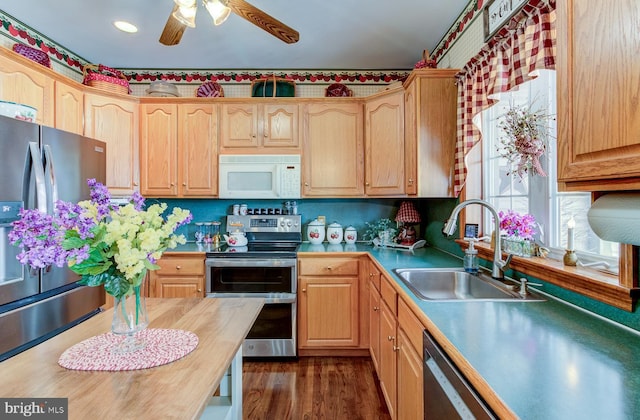 kitchen with ceiling fan, sink, light brown cabinets, stainless steel appliances, and dark hardwood / wood-style flooring