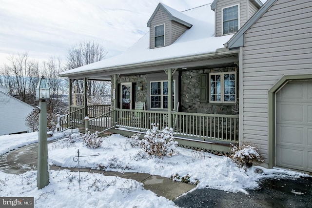 view of front facade featuring covered porch and a garage