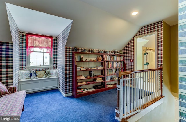 living area with lofted ceiling and carpet floors