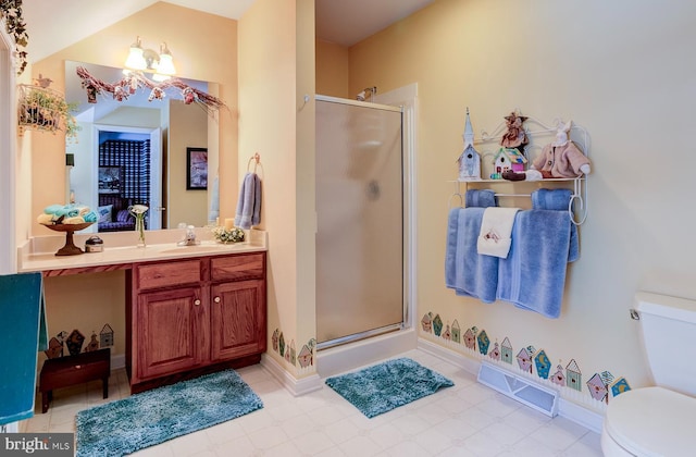 bathroom with a shower with shower door, vanity, and toilet