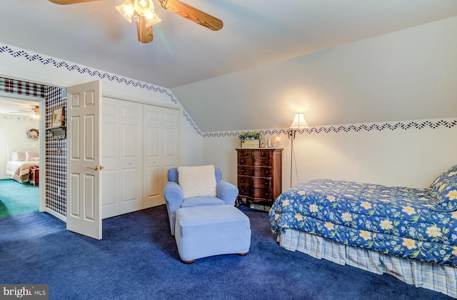 bedroom with ceiling fan, a closet, dark carpet, and lofted ceiling