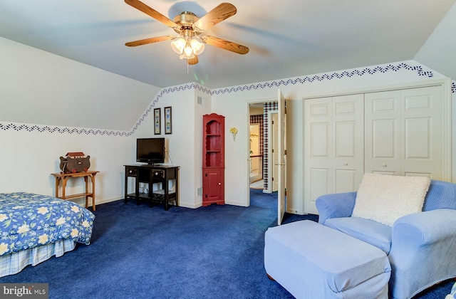 bedroom featuring ceiling fan, dark colored carpet, a closet, and lofted ceiling