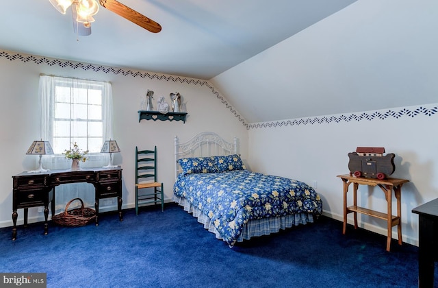 carpeted bedroom featuring ceiling fan and vaulted ceiling