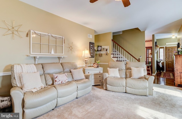 carpeted living room featuring ceiling fan