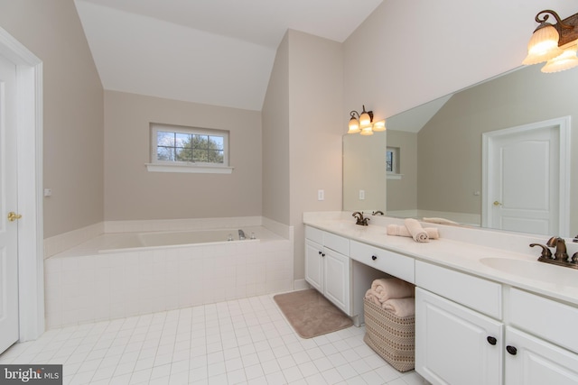 bathroom featuring tile patterned floors, vanity, and a relaxing tiled tub